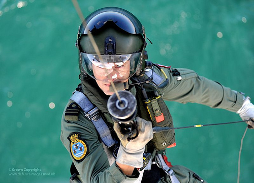 Royal Navy Search and Rescue Helicopter Aircrewman is Winched Aboard